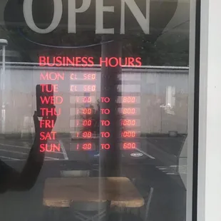 Hours posted next to door.