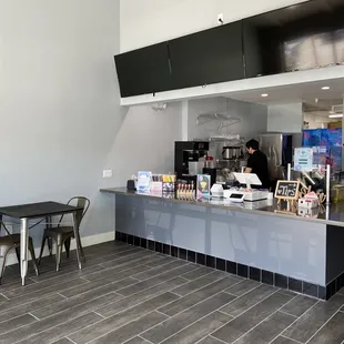 a restaurant with a counter and tables