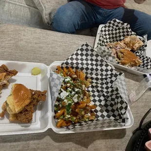 a woman sitting on a couch with a tray of food