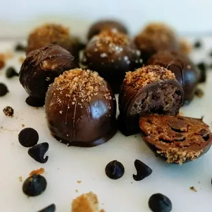 a pile of chocolate covered doughnuts