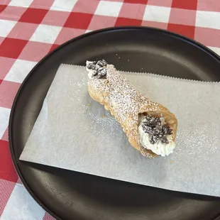 Cannoli piped fresh to order.