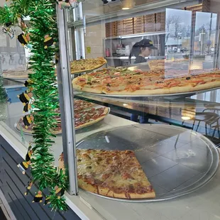 pizzas in a display case