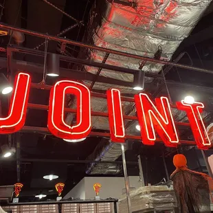 a neon sign hanging from the ceiling