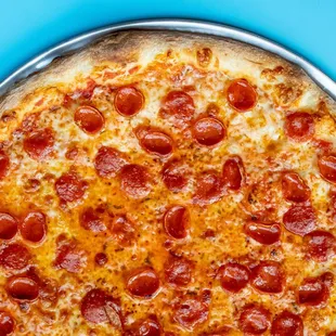 a pepperoni pizza on a pan