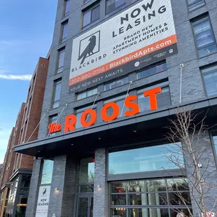 the front of a building with a sign that says the roost