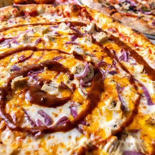 BBQ CHICKEN: 
Fresh Pizza Sauce, Mozzarella, Cheddar, Chicken, Red Onion, Basil