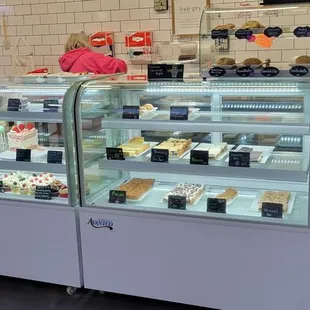 a woman behind a bakery counter