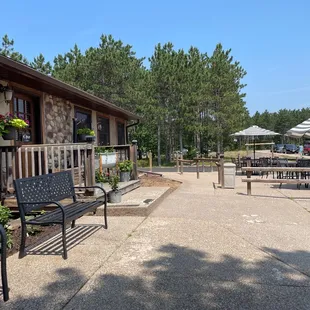 a patio area with benches and tables
