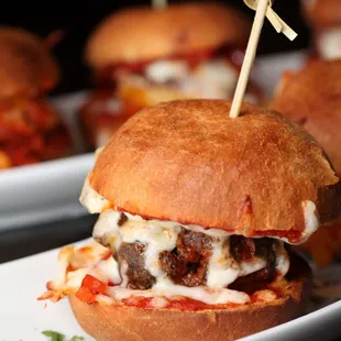 a cheeseburger on a plate with toothpicks