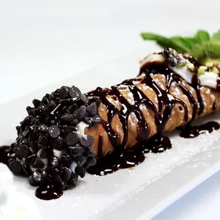 a chocolate dessert with strawberries and whipped cream