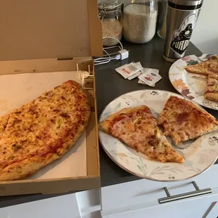 two slices of pizza in a pizza box