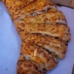 Original Philly Steak calzone. It&apos;s a large folded in half. Full of stuff. Not soggy! Ginormous! And delicious! With Italian sauce inside.