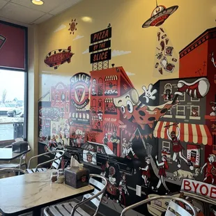 a restaurant with a large mural