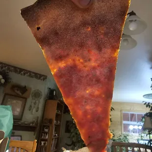 Soaked in grease. Very thin crust.