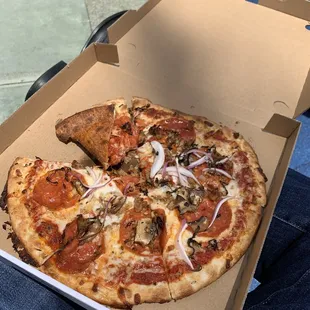 Custom pizza with red sauce, sausage, pepperoni, mushroom, onion, garlic, and basil.   Took a bite first. Oops.