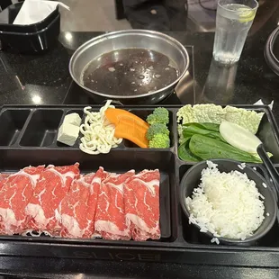 Beef, veggies, noodles, rice and sukiyaki broth.