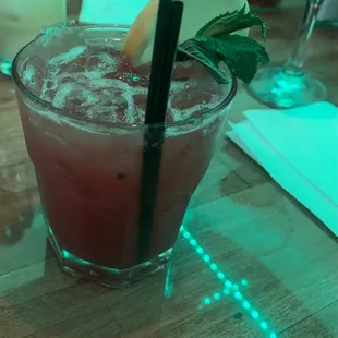a glass of cocktail on a table