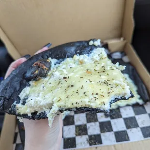 A slice of the 'White Witch' black-crusted pizza