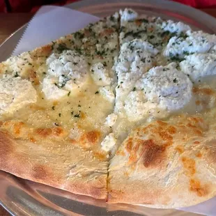 Two slices of the white pizza