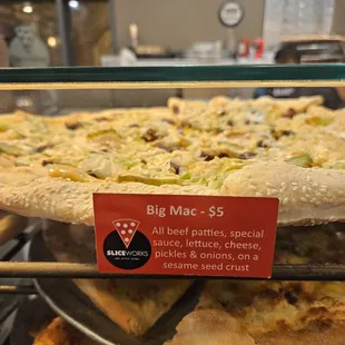 a display of pizzas in a glass case