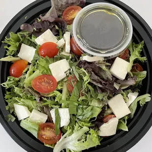 a salad in a black bowl