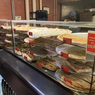 a variety of pies in a display case