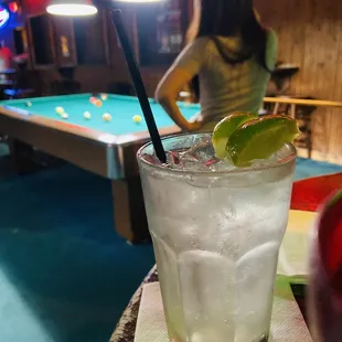 a woman with a pool table in the background