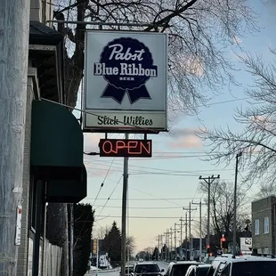 Slick Willie's sign with a sweet sunset &amp; some Midwestern March snow on the ground.