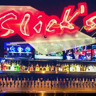 a neon sign above the bar
