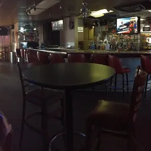 a bar with tables and chairs