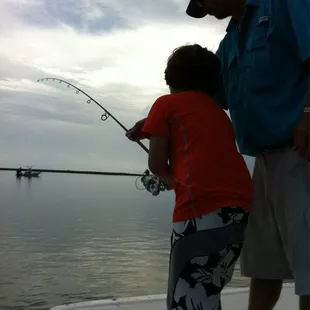 Capt slick helping teach my son how to reel in a big one