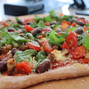 a close up of a pizza on a cutting board