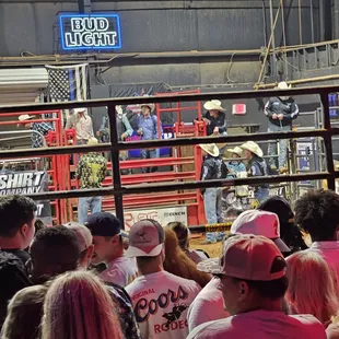 a crowd of people watching a rodeo