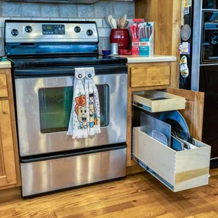 Narrow cabinets are a perfect spot for a slide out and and divided bin!