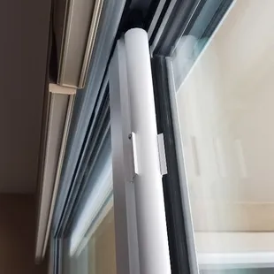 The closing tube is mounted to the back frame of the slider. A weight and cable system uses gravity to automatically close the door.