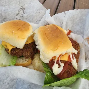 two sliders with cheese and lettuce