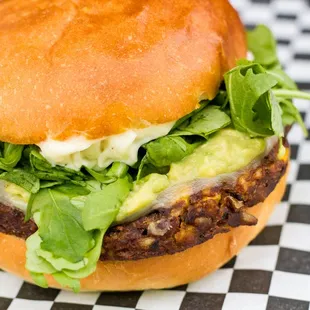 a burger with lettuce and cheese