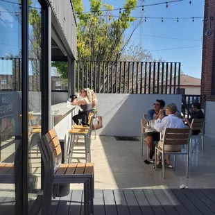 people sitting at tables outside
