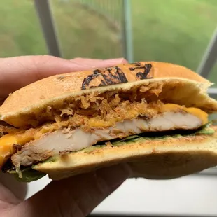 a chicken sandwich with cheese and lettuce