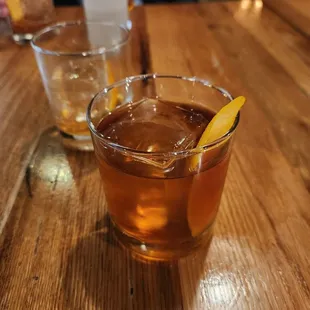 two glasses of alcohol on a wooden table