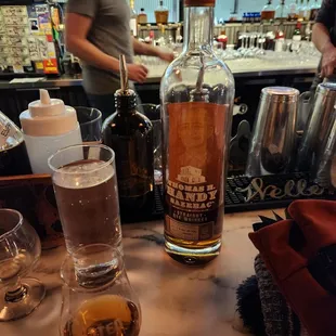 a glass of whiskey and a bottle of liquor