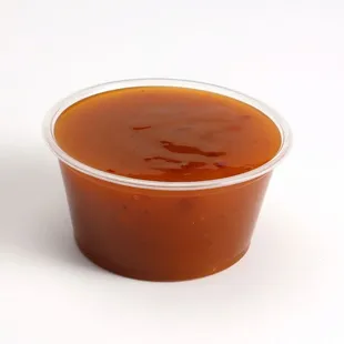 a plastic cup of ketchup