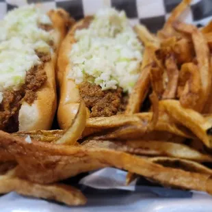 Two Mad Dogs (Deep fried, bacon wrapped hot dogs) topped with chili, cheese, and slaw with a side of fries.
