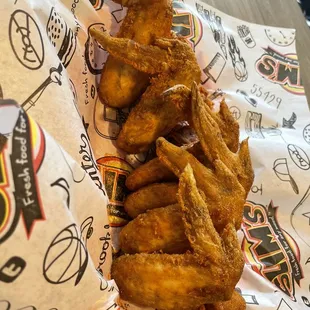 a pile of fried chicken on a wrapper