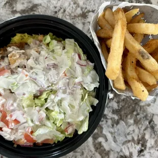 Chicken bowl with white sauce and a large fries