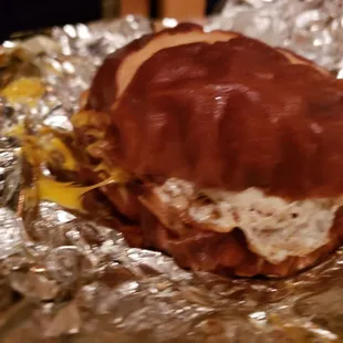 a bacon and cheese sandwich wrapped in foil