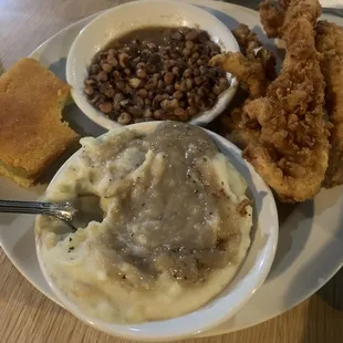 Purple hull peas, fried chicken tenders and mashed potatoes with gravy.