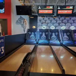 a bowling alley with bowling pins and bowling balls