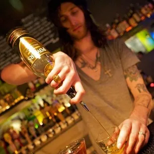 a bartender pouring a drink