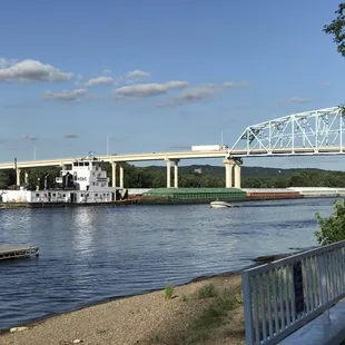 a river with a bridge in the background